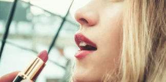 A woman's lips adorned with perfectly applied red lipstick, showcasing professional makeup techniques.