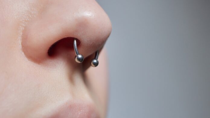 A septum piercing is a type of body modification where the thin strip of skin between the nostrils, known as the septum, is pierced.