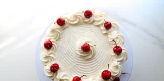 Delicious white chocolate cake with creamy frosting on a platter.