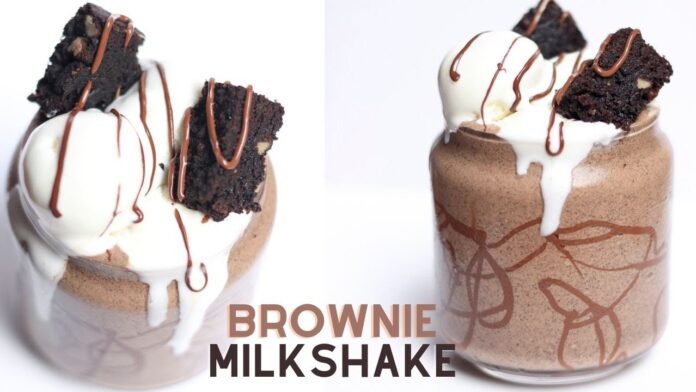Decadent brownie milkshake with whipped cream on top, served in a glass.