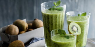 Refreshing kiwi smoothie in glass with straw, a healthy and delicious drink for summer. Fresh fruit blended to perfection.
