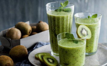 Refreshing kiwi smoothie in glass with straw, a healthy and delicious drink for summer. Fresh fruit blended to perfection.