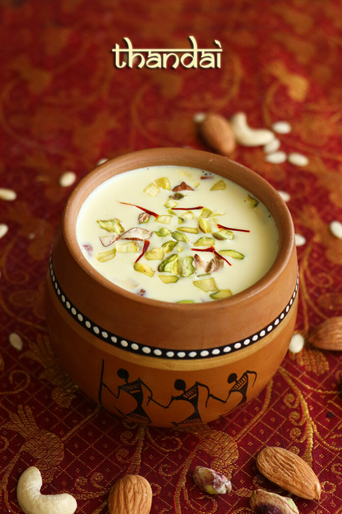 Refreshing Thandai Recipe - Traditional Indian Drink Blend with Almonds, Cardamom, and Saffron in a Glass Garnished with Pistachios and Rose Petals