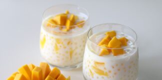 Delicious homemade creamy mango sago dessert served in a glass, featuring fresh mango chunks and tapioca pearls in a rich, creamy coconut milk base. Perfect summer treat for mango lovers!