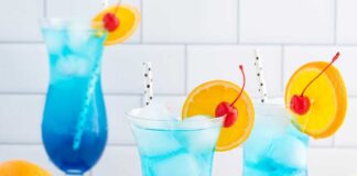 Refreshing Blue Lagoon Mocktail recipe: A tropical-inspired beverage with a vibrant blue hue, combining lemonade, pineapple juice, and a hint of coconut cream, garnished with fresh fruit and served over ice. Perfect for summer parties or non-alcoholic gatherings.
