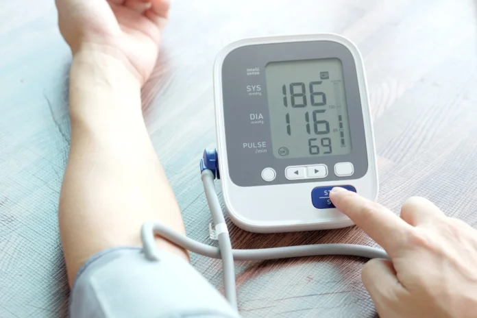 Person Checking Blood Pressure with Monitor - Learn How to Control BP Naturally